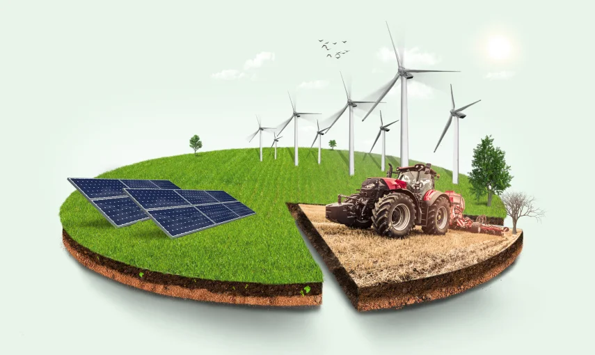 Solar panels, wind turbines and a tractor on farmland